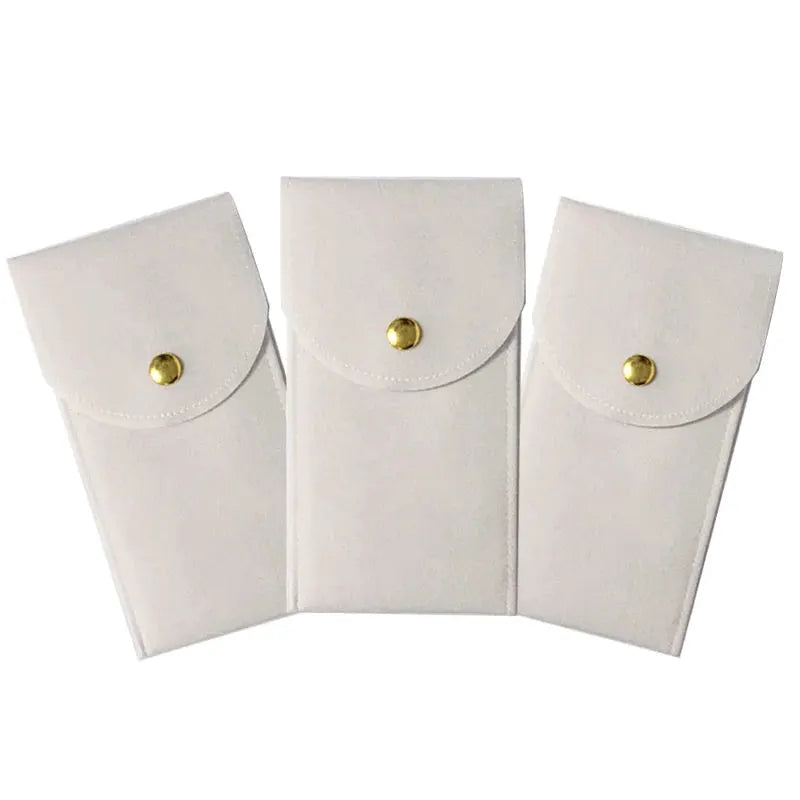 Watch storage pouches set of 3 white flannelette bags with gold snap closures.