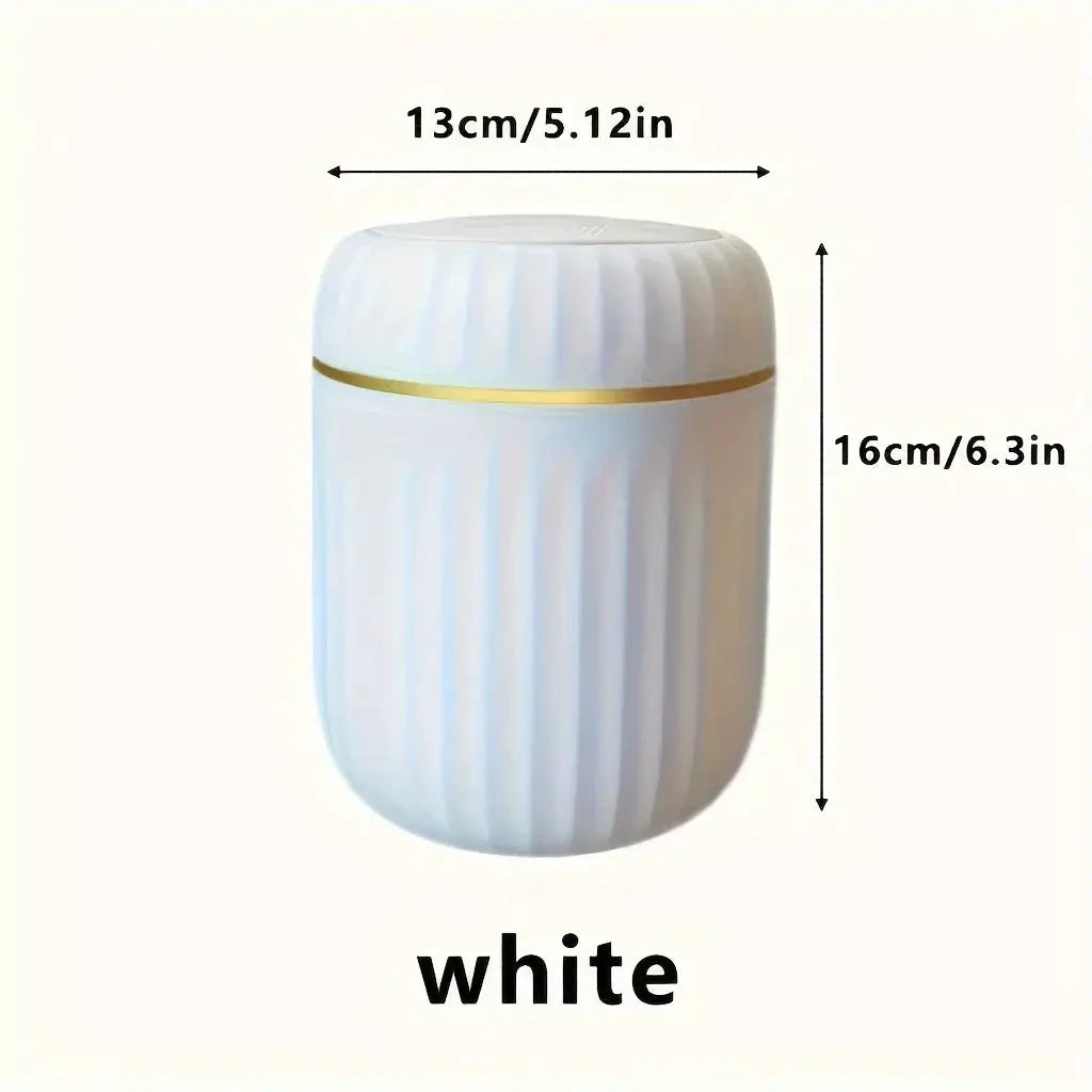 Mini desktop trash can, white plastic with a gold band, lid included, compact desk waste bin.