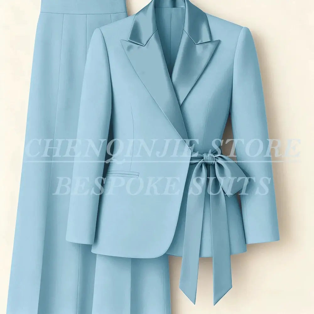Pastel blue 2-piece blazer and pants suit for women with peak lapel and belt-tie waist.