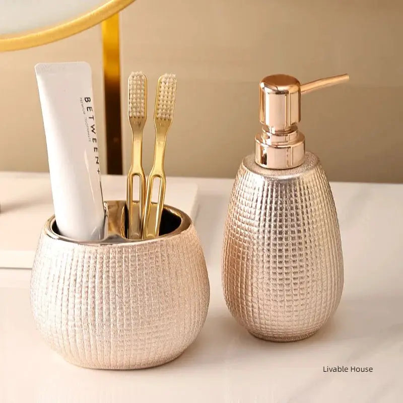 Rose gold ceramic bathroom accessories set with toothbrush holder and soap dispenser by Simples Market