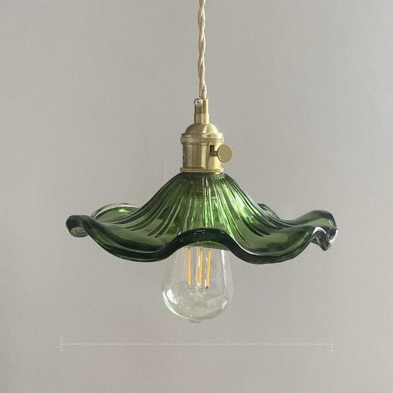 Green glass Nordic pendant light with a wavy shade and brass hardware, LED bulb