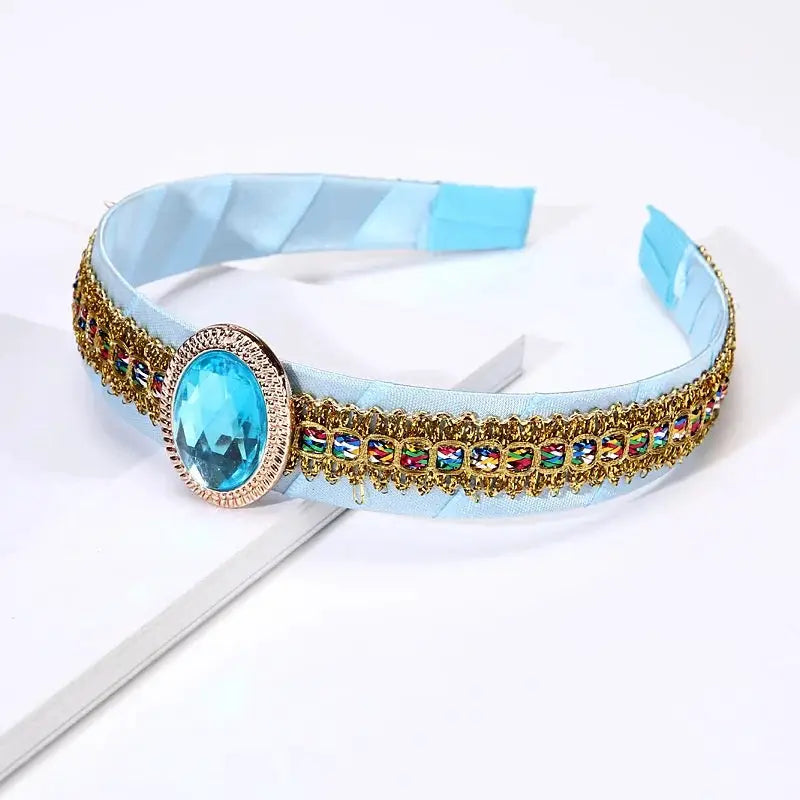 Simples Market Frozen Elsa Crown headband for girls with blue gemstone centerpiece and gold trim on light blue band