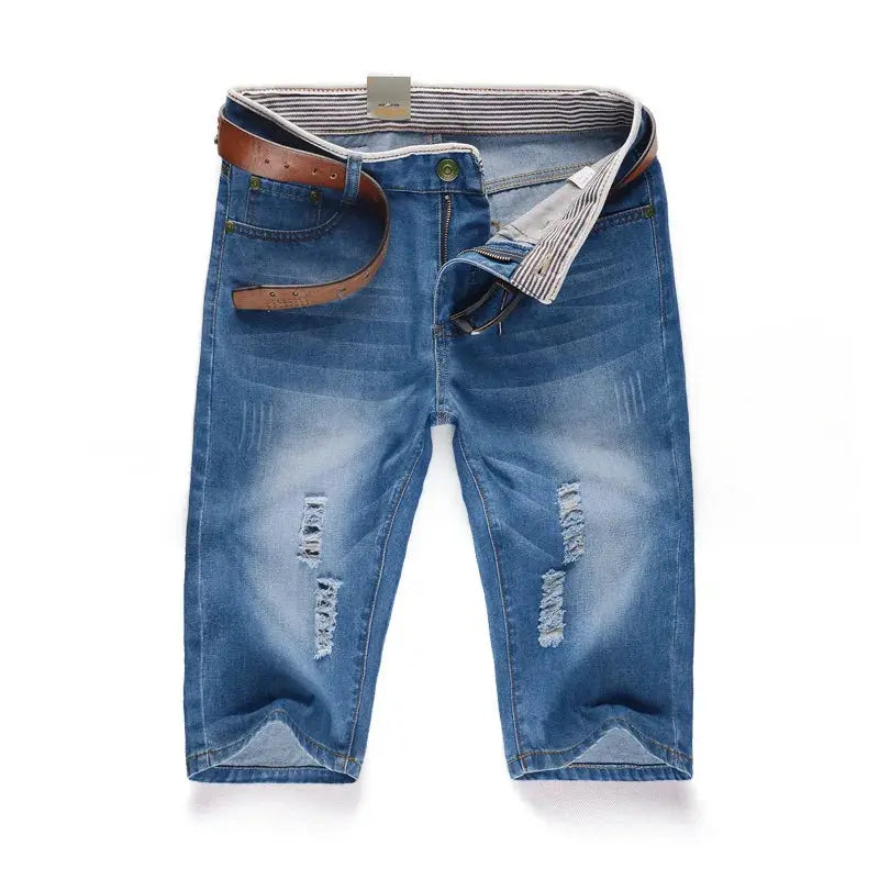 Men's blue denim jeans with distressed patches, belt, and striped inner waistband.