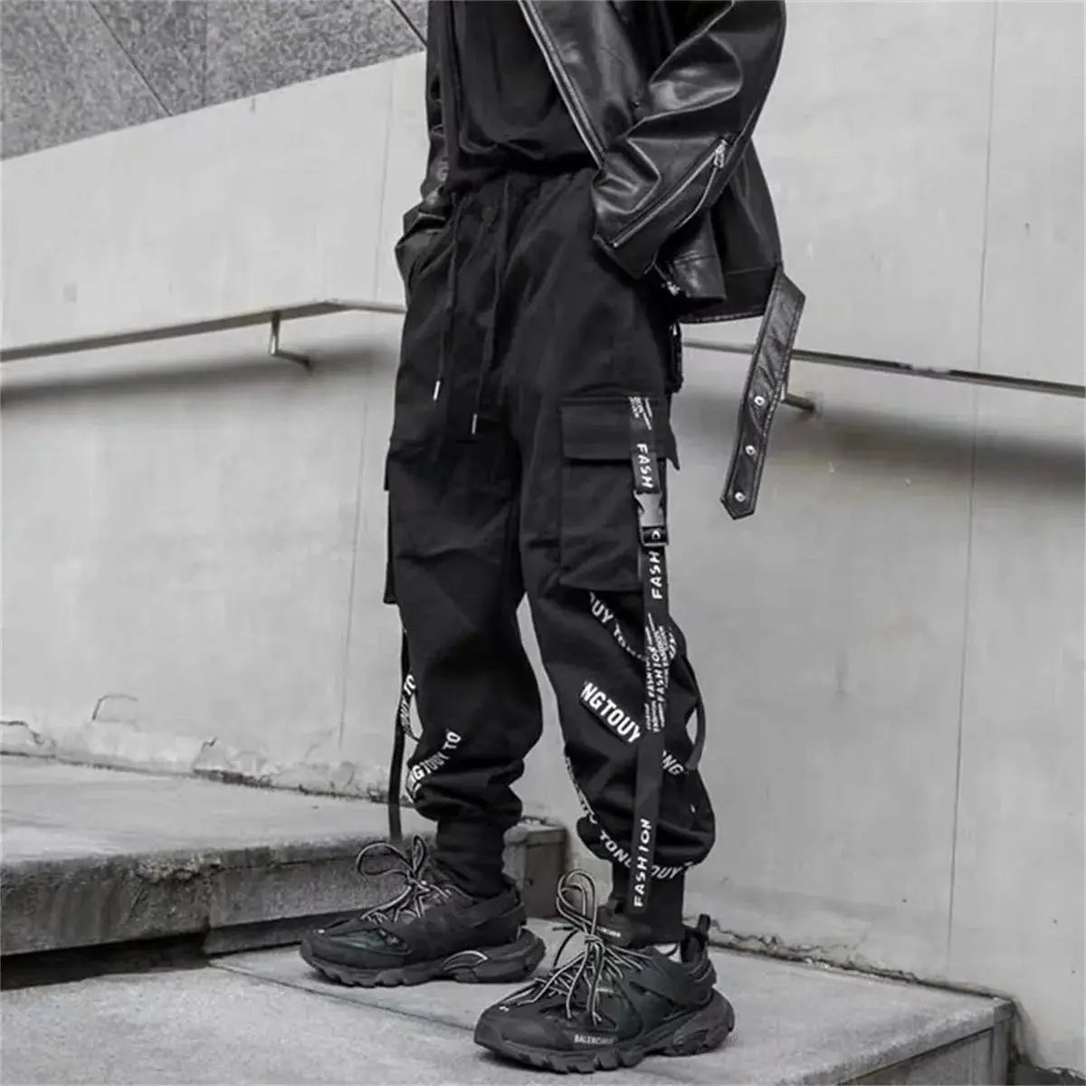 Black cargo jogger pants for men with ribbon strap details, streetwear techwear inspired