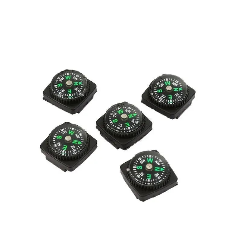 Five small black outdoor compasses with green markings for camping and orienteering