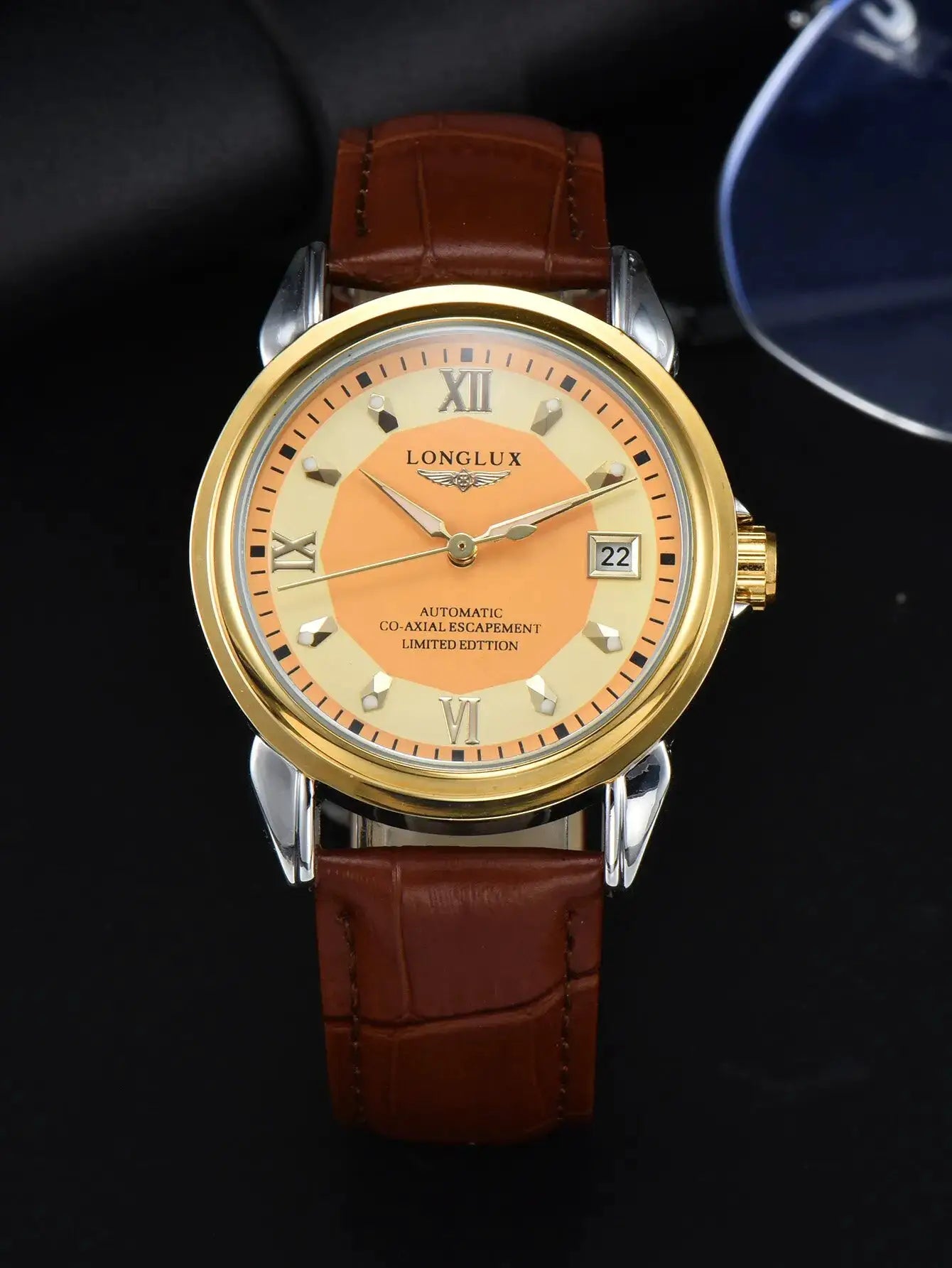 LONGLUX automatic men's wristwatch with gold case, peach dial, brown leather strap, date display.