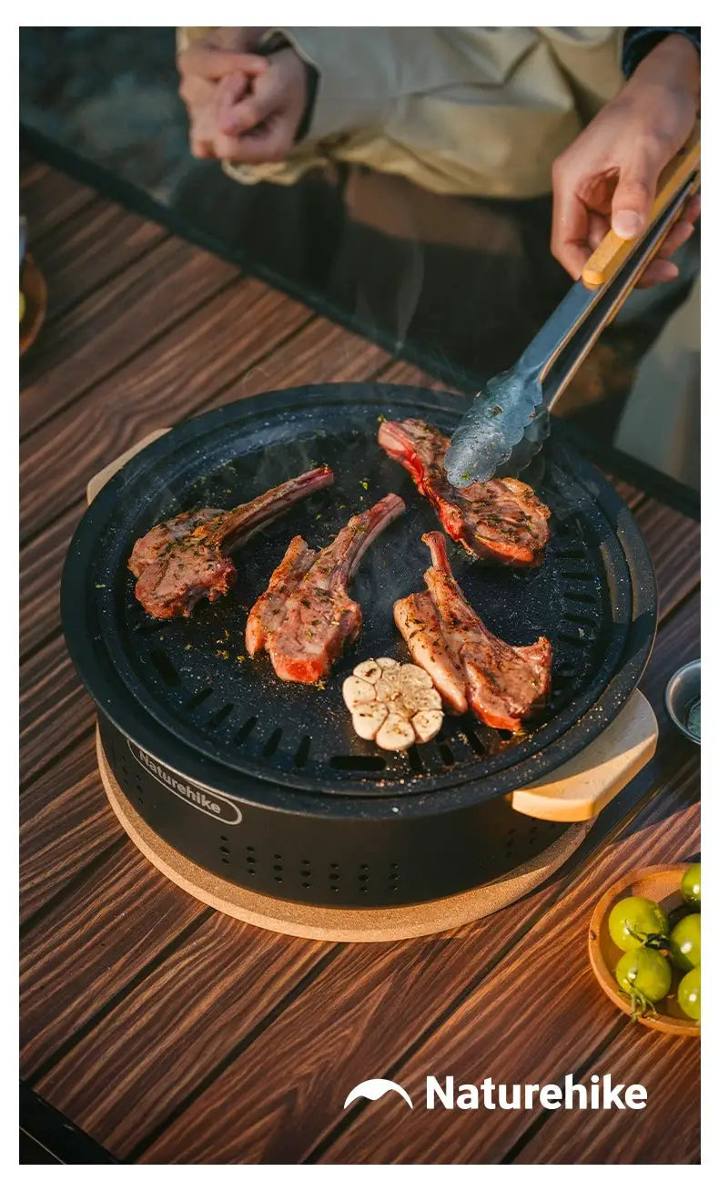 Naturehike outdoor tabletop barbecue stove with charcoal grill cooking meat; Naturehike logo visible