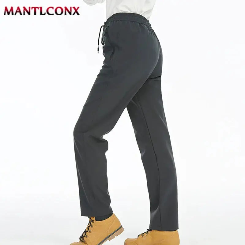 Breathable men's jogger sweatpants with an elastic waistband in dark gray, quick-dry fabric, MANTLCONX logo.
