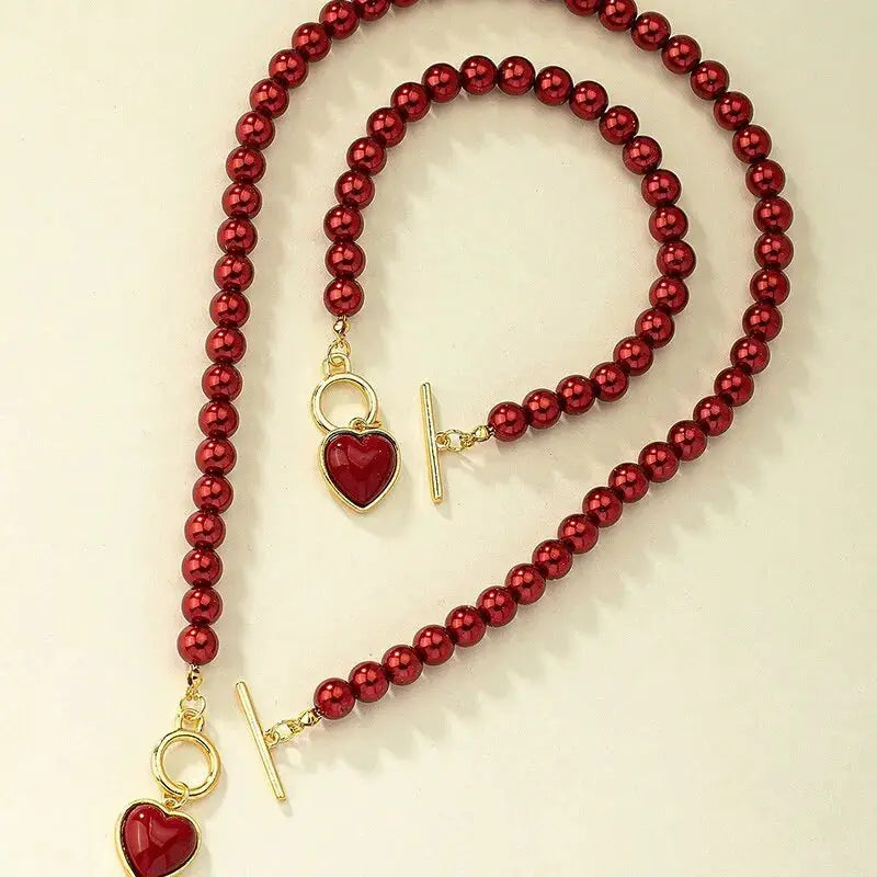 2-Piece red bead necklace and bracelet set with gold-tone heart pendants