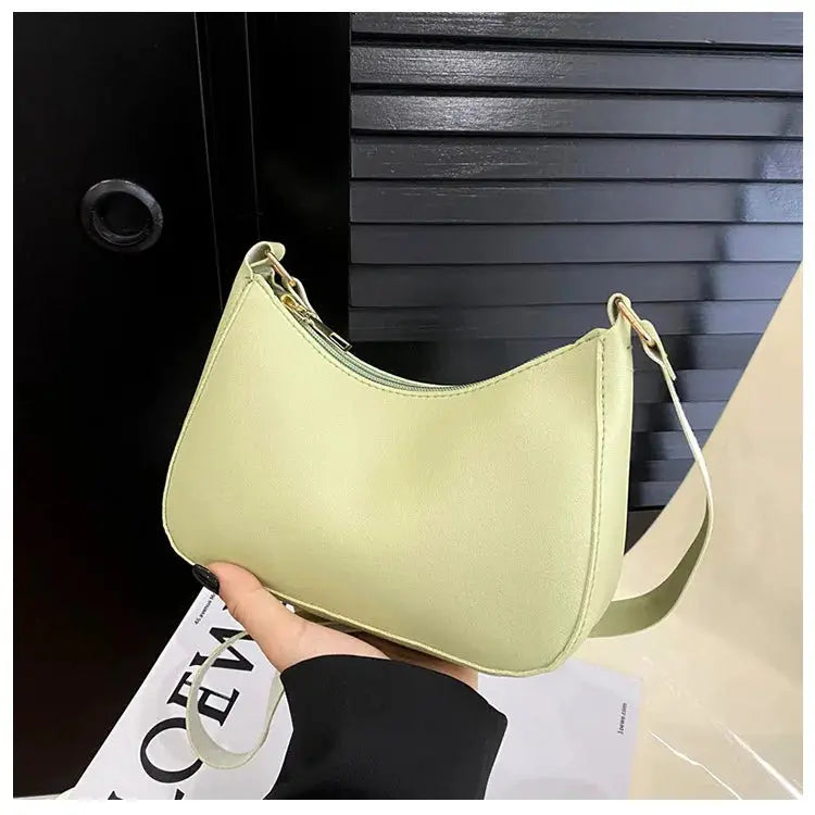 Pale-green small shoulder bag, solid-color faux-leather with a single strap.