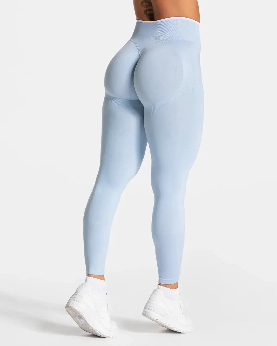 Women's light-blue seamless knitted yoga leggings, high-waisted hip-lifting with white edge detail from Simples Market