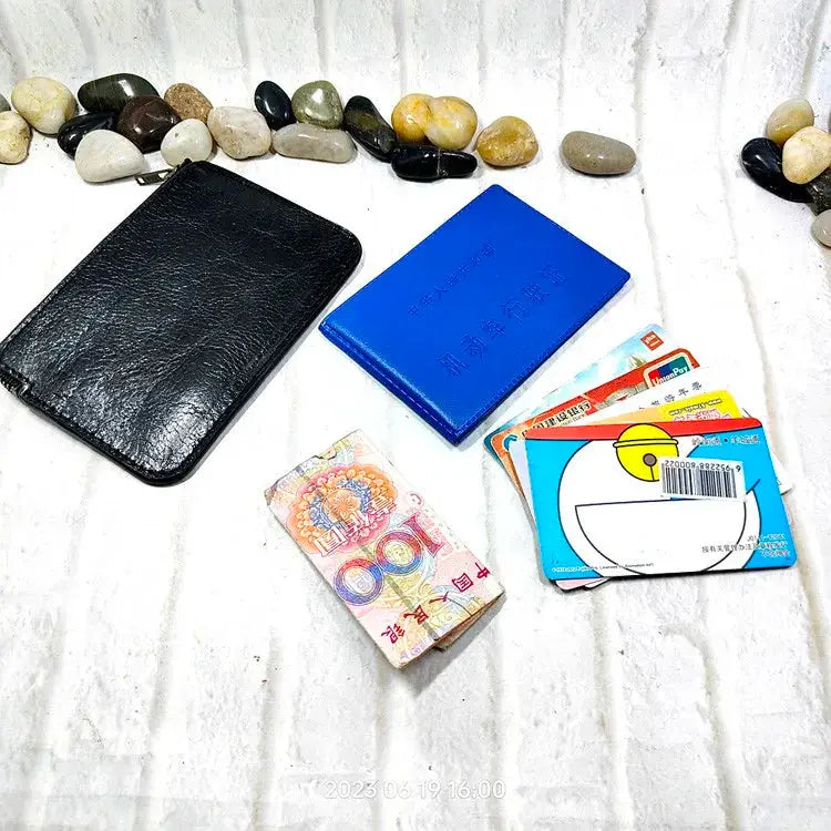 Mini zipper waist bag in black leather with blue cardholder, cards and cash.