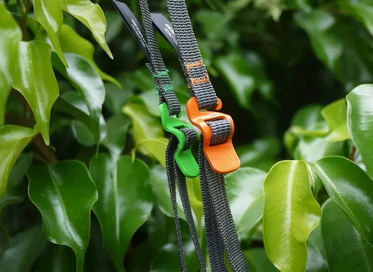 Luggage strap set with two quick-release buckles; black nylon straps with green and orange release parts