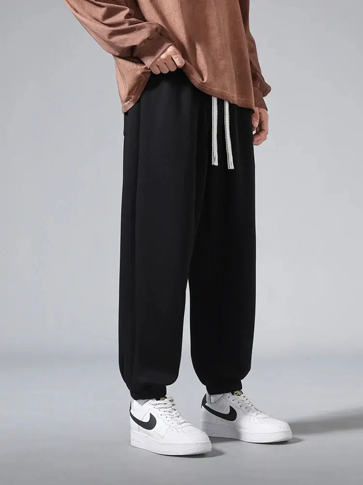 Men's black baggy jogger pants (cotton/polyester), big-size 6XL/7XL/8XL with drawstring waist and cuffed ankles.
