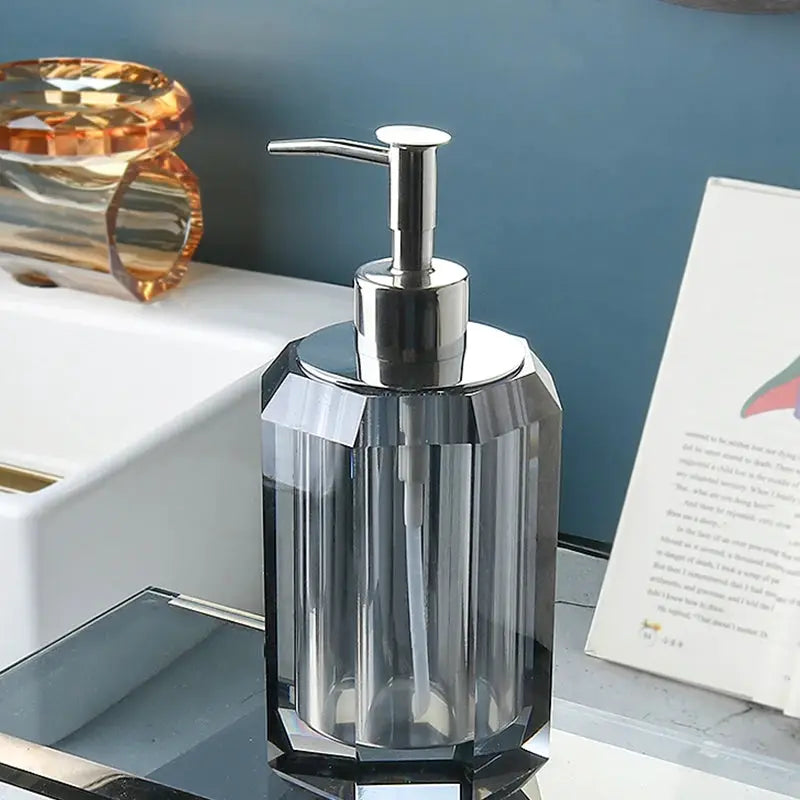 Clear crystal glass lotion bottle with chrome pump, featuring multifaceted crystal facets for a chic bathroom display.