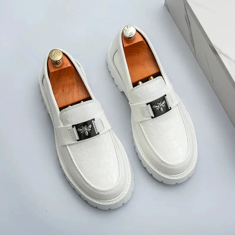 Pair of white leather loafers by Simples Market with bee buckle and thick sole