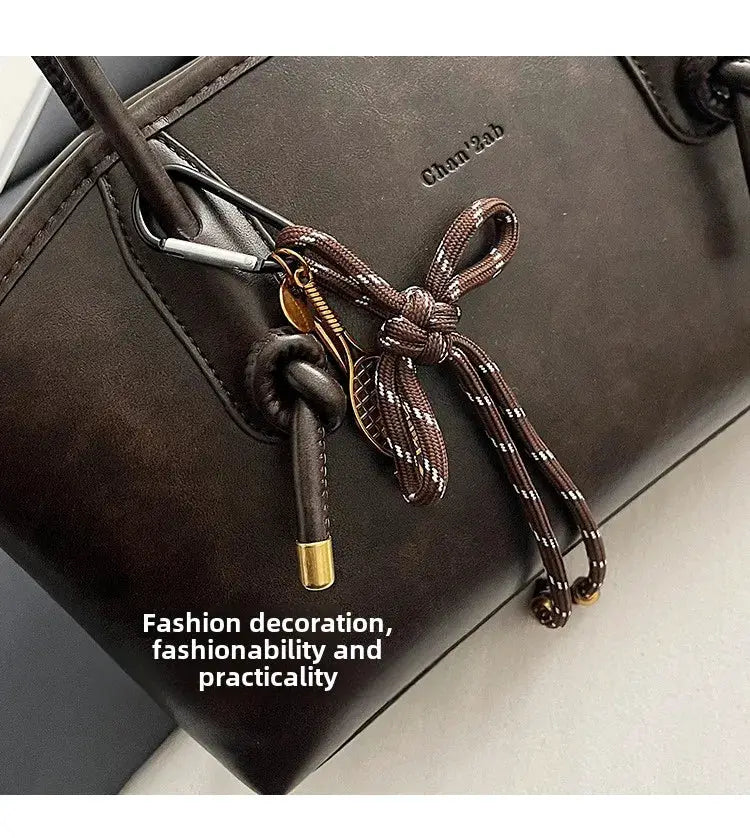 Simples Market PU leather shoulder bag for women, dark brown crossbody with tassel knot accessory.