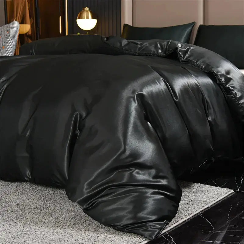 3-piece black satin duvet cover set on bed; silky, luxurious sheen