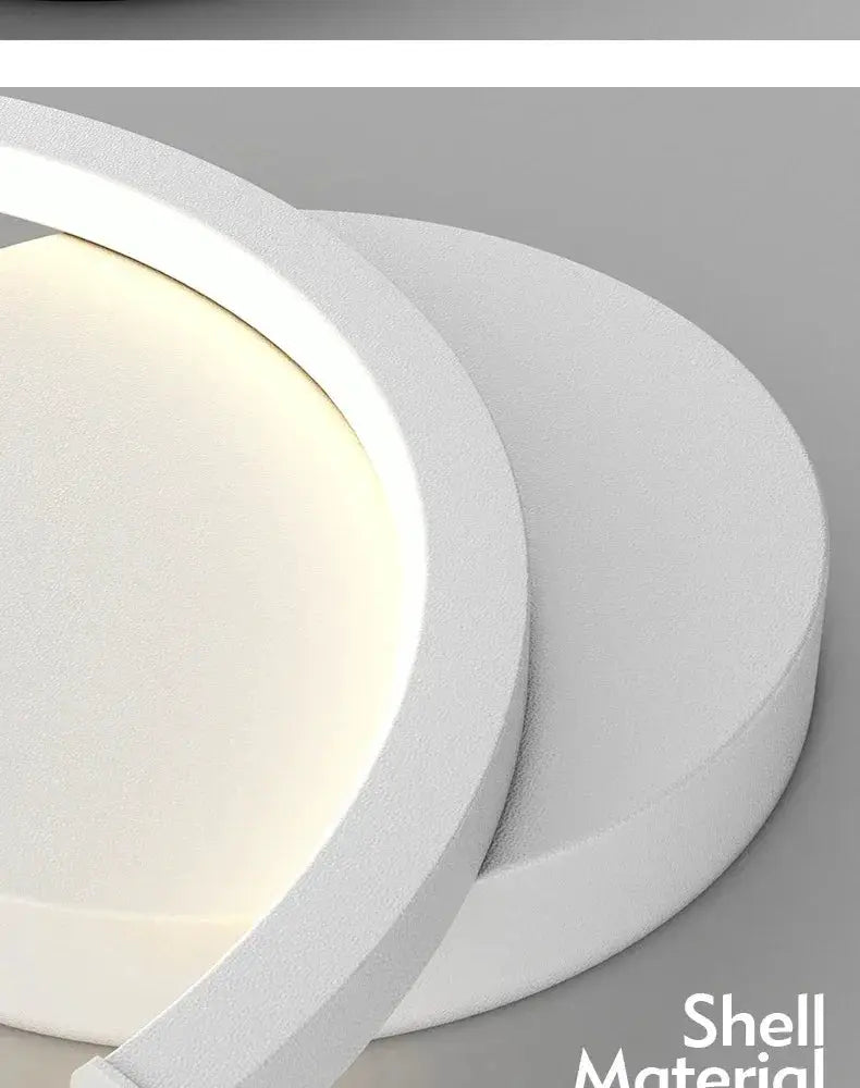 Modern LED wall lamp, white circular Nordic design with warm halo glow for living room or bedroom.