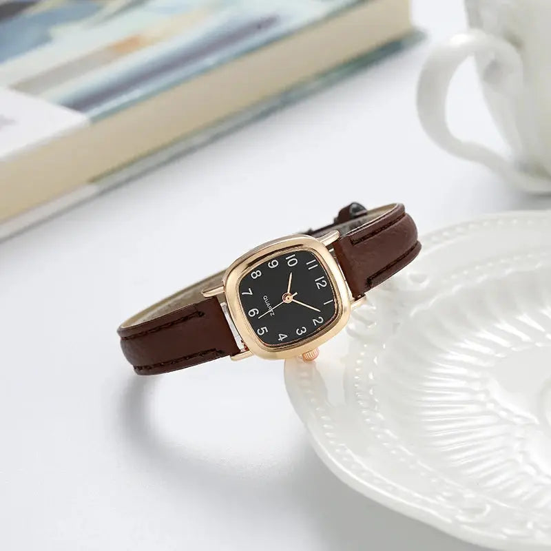 Women's quartz watch with brown leather strap and black dial