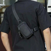 Men's Oxford small crossbody bag in black with front zip pocket and adjustable strap