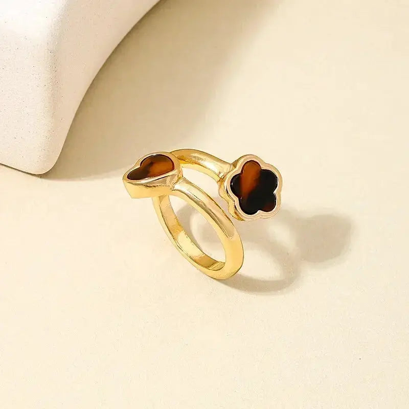 Exaggeration Punk ring set in gold-tone metal with heart- and flower-shaped brown stone accents, adjustable