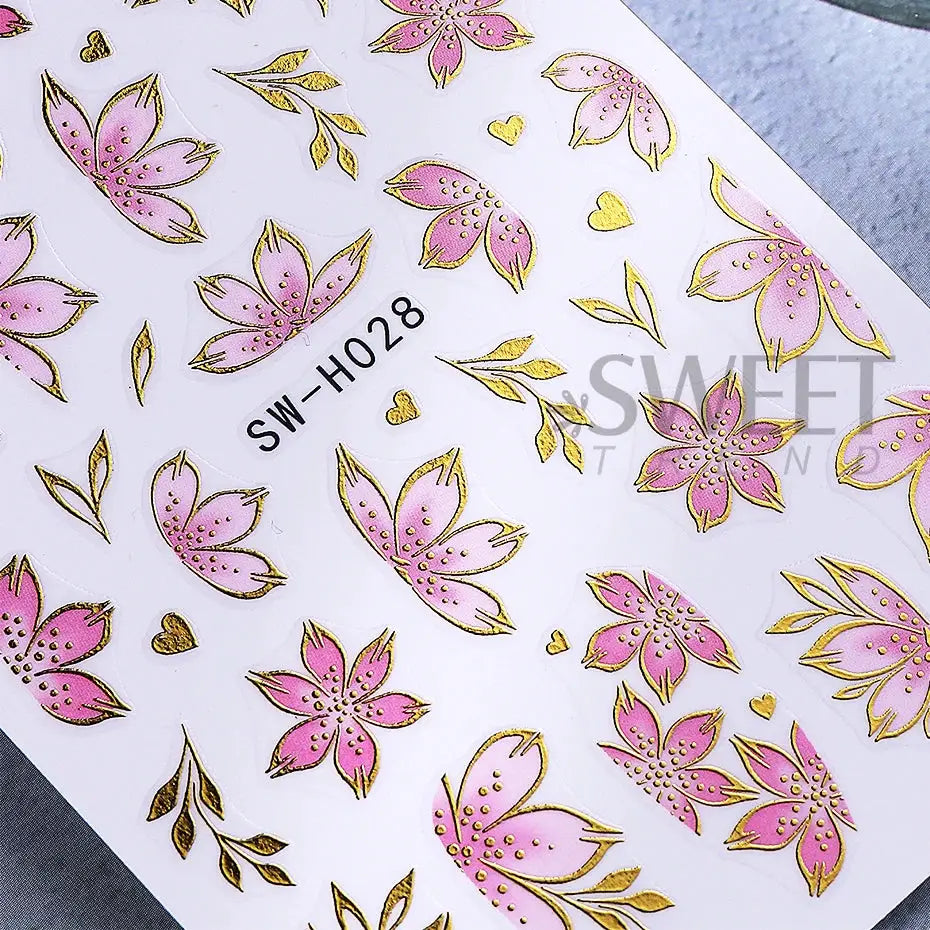 Nail stickers sheet with golden pink hibiscus flowers and bronze borders for DIY manicure decor