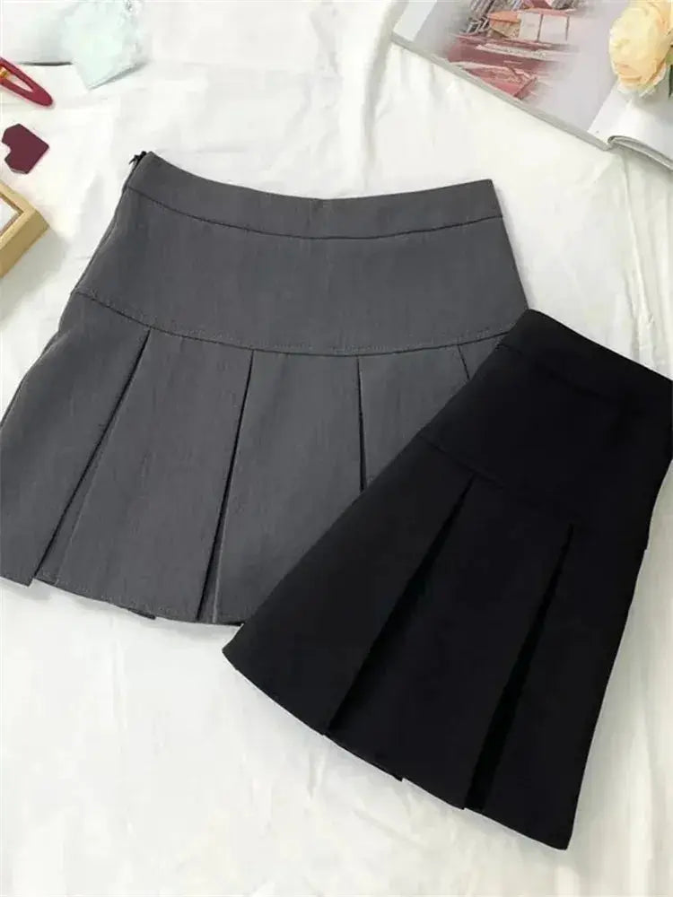 Two pleated mini skirts in gray and black with high-waist, school-uniform style.