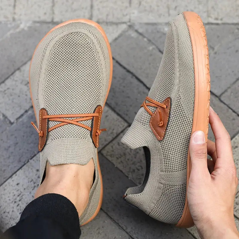 Barefoot shoes by Simples Market; beige knitted sneakers with tan sole and brown leather lace patch, pair.