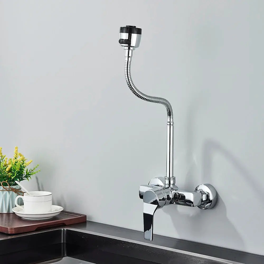 Chrome wall-mounted kitchen faucet with flexible coiled hose and spray head.