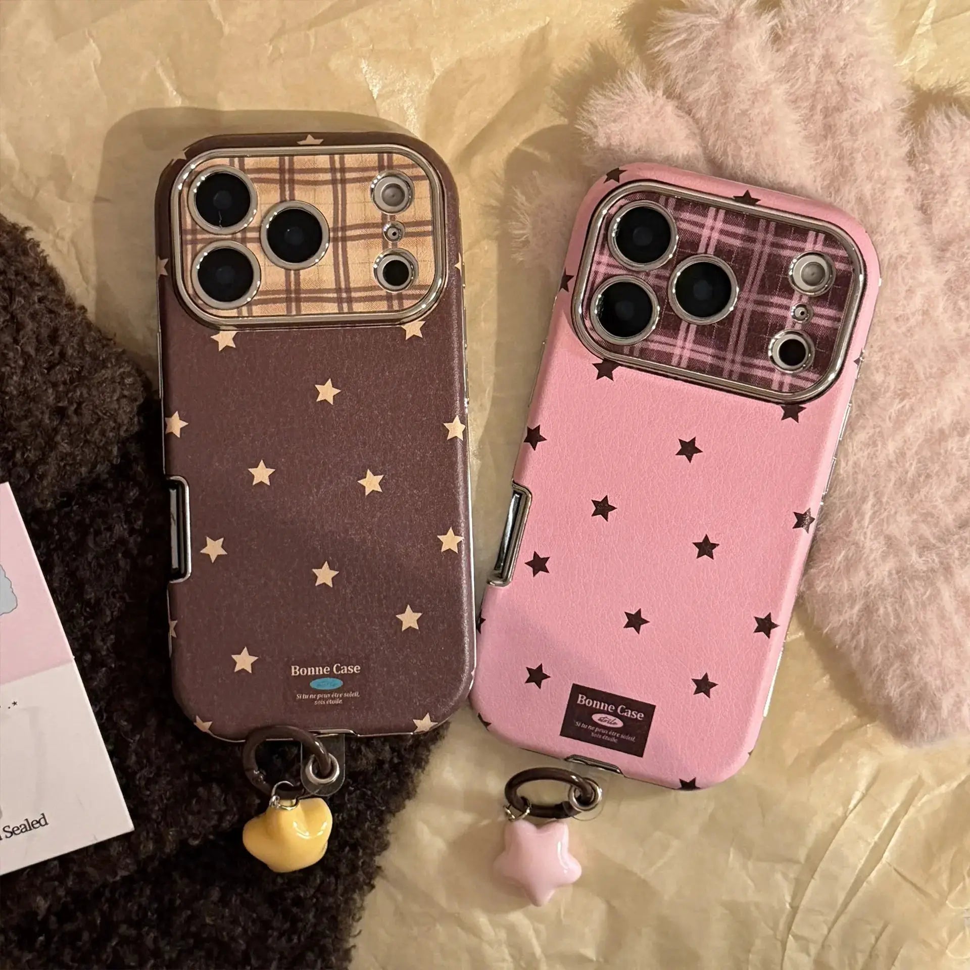 Two Bonne Case leather-texture phone cases with Korean retro stars and plaid interior, brown and pink, pendant charms