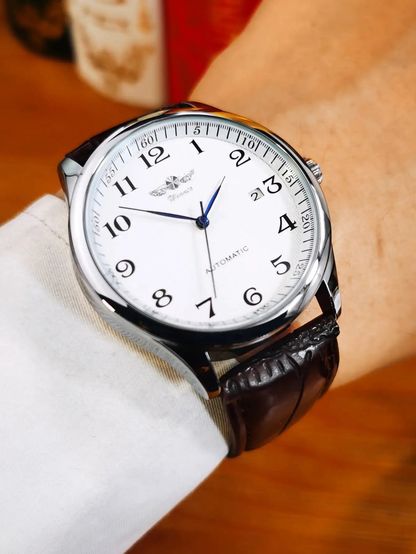 WINNER men's fashion business watch with white dial, blue hands, stainless steel case and leather strap