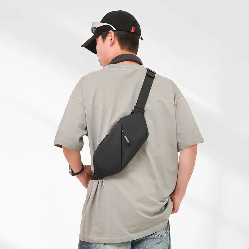 Men's minimalist waterproof waist bag; black crossbody fanny pack with zip pocket