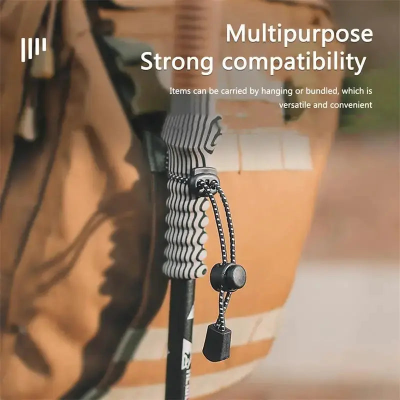 Elastic rope backpack trekking pole holder with adjustable bungee cord and cord lock.