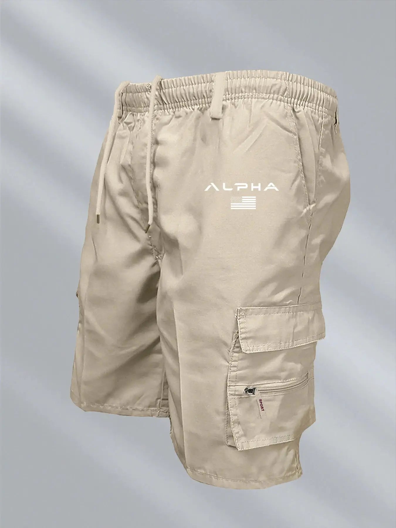 Men's beige cargo shorts with drawstring waist and multiple pockets; ALPHA logo on thigh.