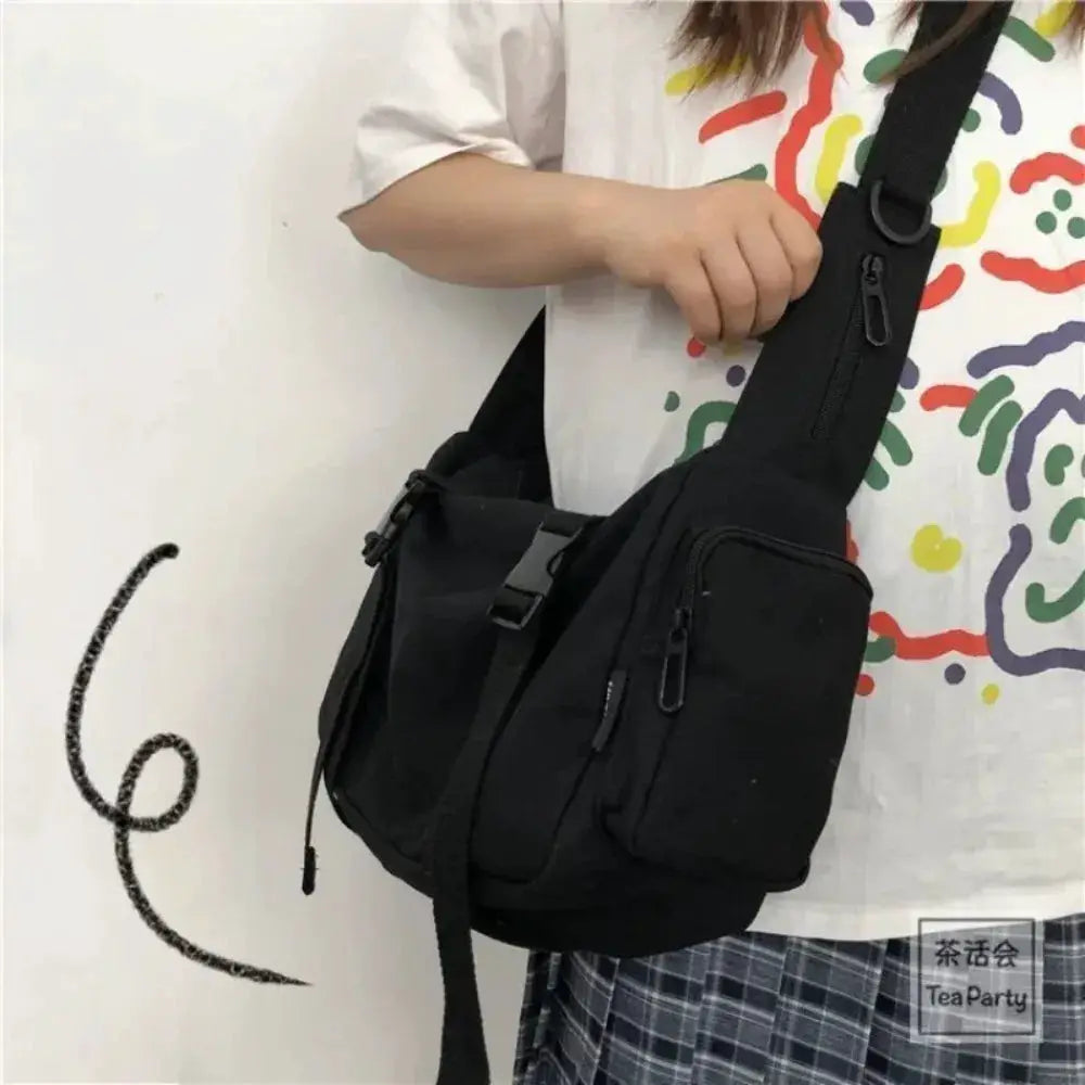 Simples Market canvas crossbody bag in black with multiple zip pockets and an adjustable strap