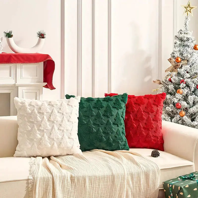 3 Christmas decorative pillow covers in white, green, and red with a textured tree pattern on a cream sofa
