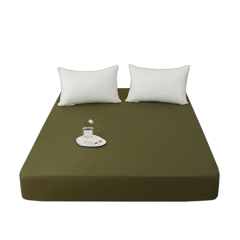 Simples Market olive green fitted sheet, 100% polyester with elastic edges on a bed, shown with two white pillows
