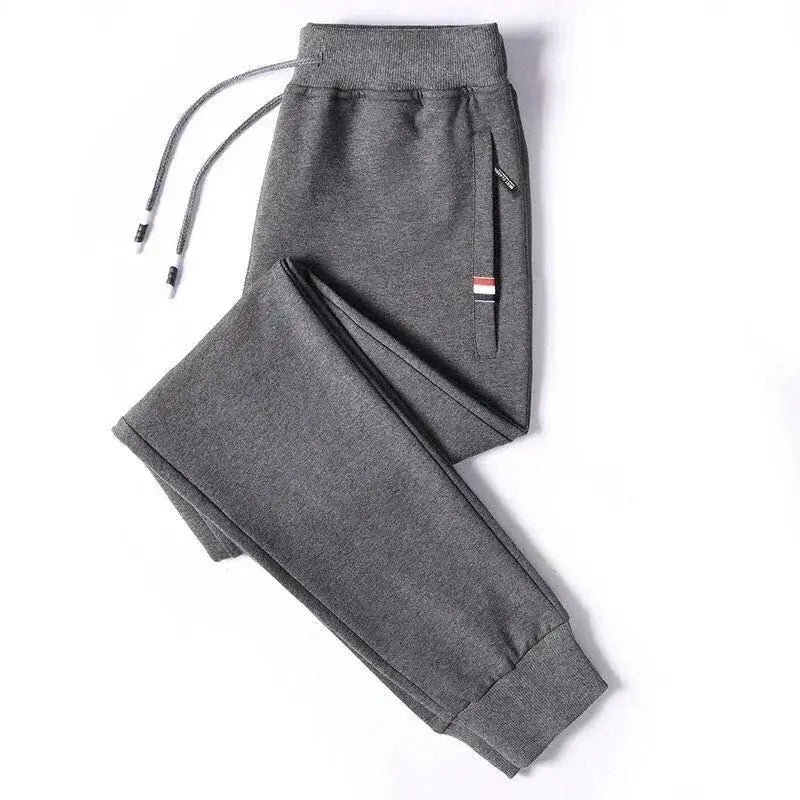 Men's grey jogger sweatpants with elastic waistband, drawstring and zip pocket for gym