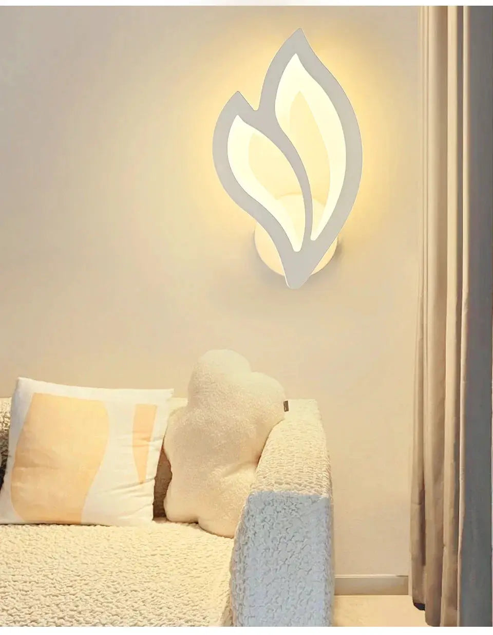 Modern LED wall lamp with white leaf-shaped design and warm glow for living room decor.