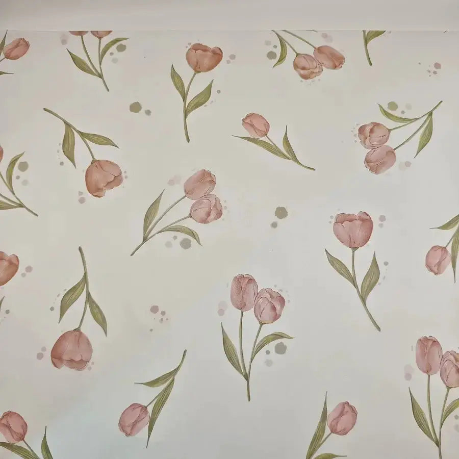 Tissue paper with soft pink tulip blossoms and green leaves on white background for gift wrapping and decorative accents