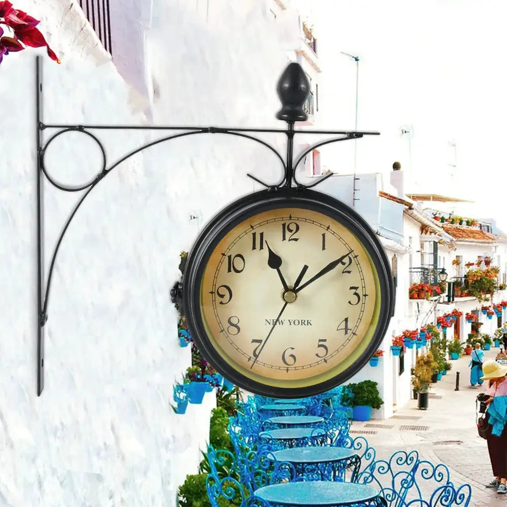 Wall clock on a decorative black metal bracket; antique beige dial with black numerals and New York text.