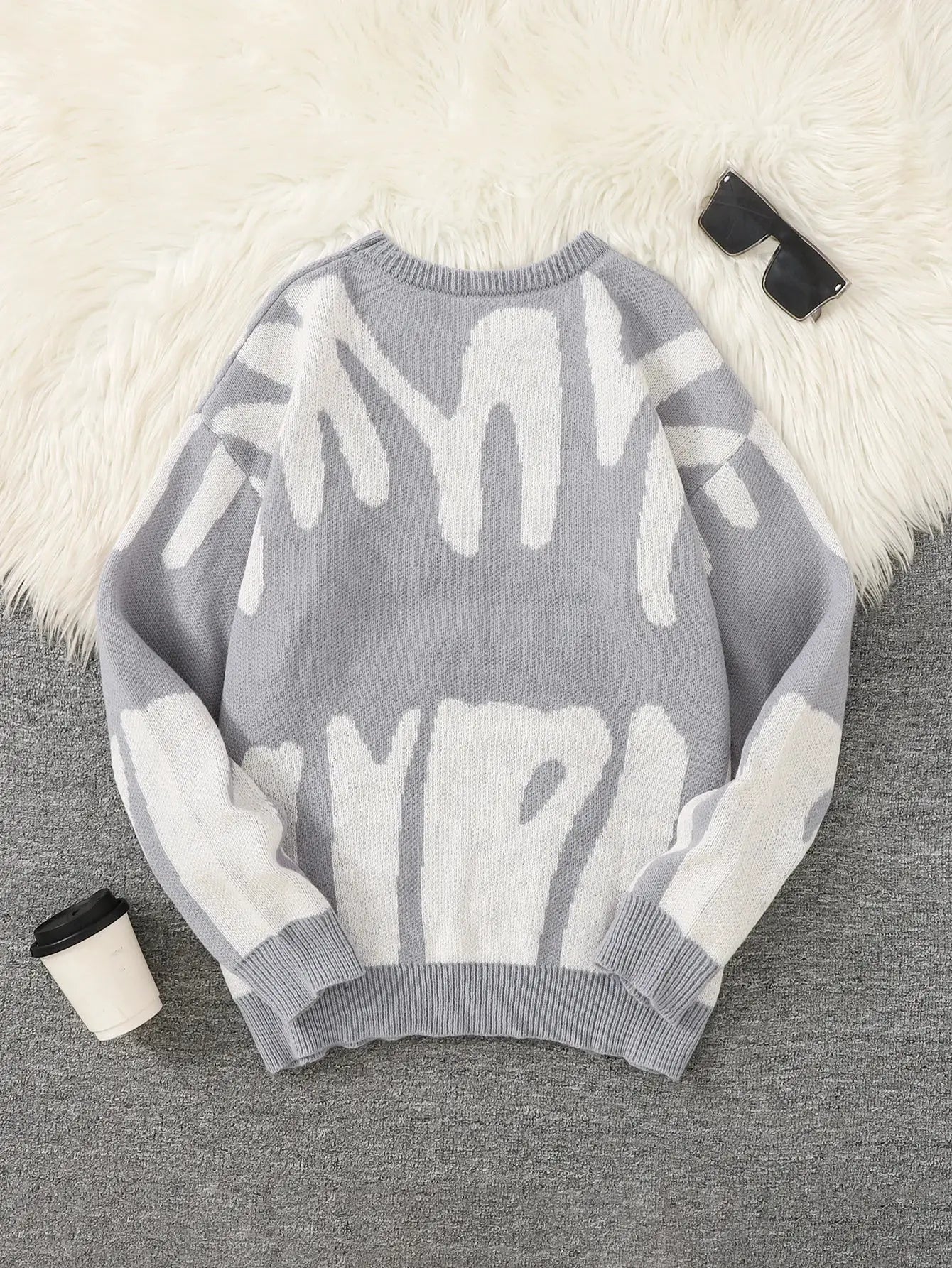 Men's pullover sweater by Simples Market; grey knit with irregular white jacquard pattern.