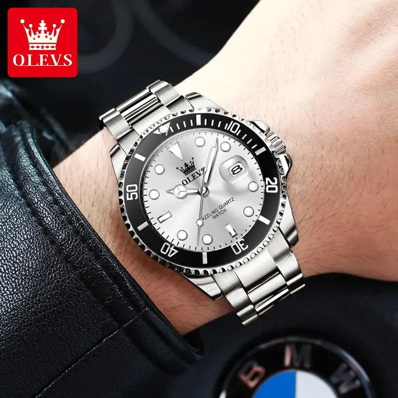 OLEVS 5885 stainless steel diving quartz watch on wrist with black bezel, date window, and visible OLEVS logo