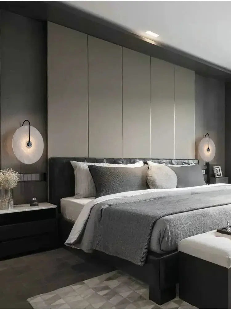 Nordic LED marble moon wall sconces flanking a modern bedroom bed with gray bedding.