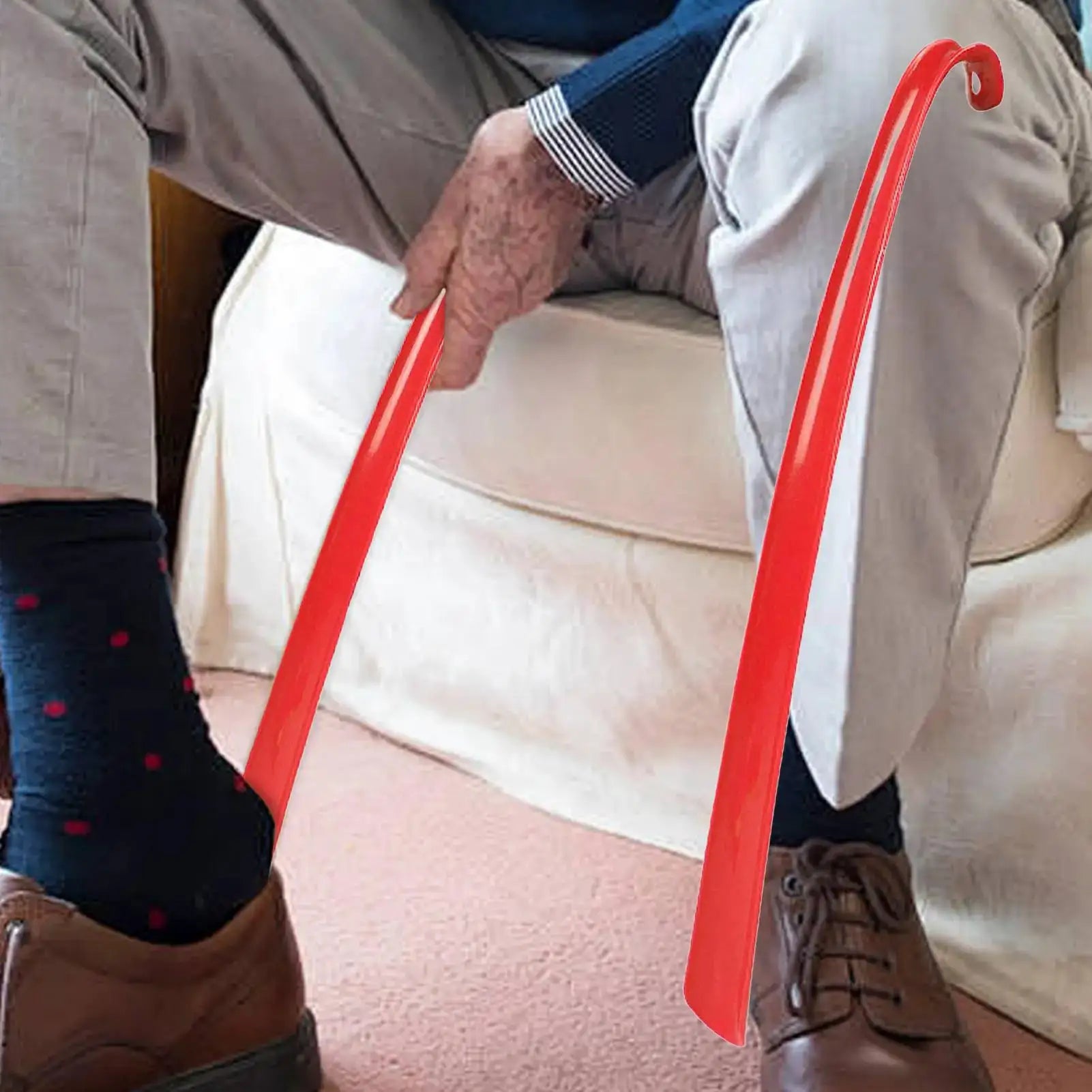 Plastic extra-long red shoehorn with long handle for easy shoe fitting