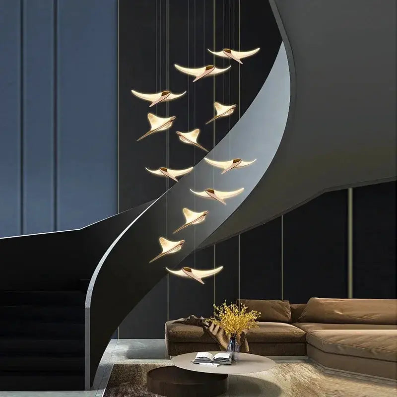 Seagull Staircase Pendant Lamp by Simples Market; golden bird-shaped pendants along a staircase in a modern living space