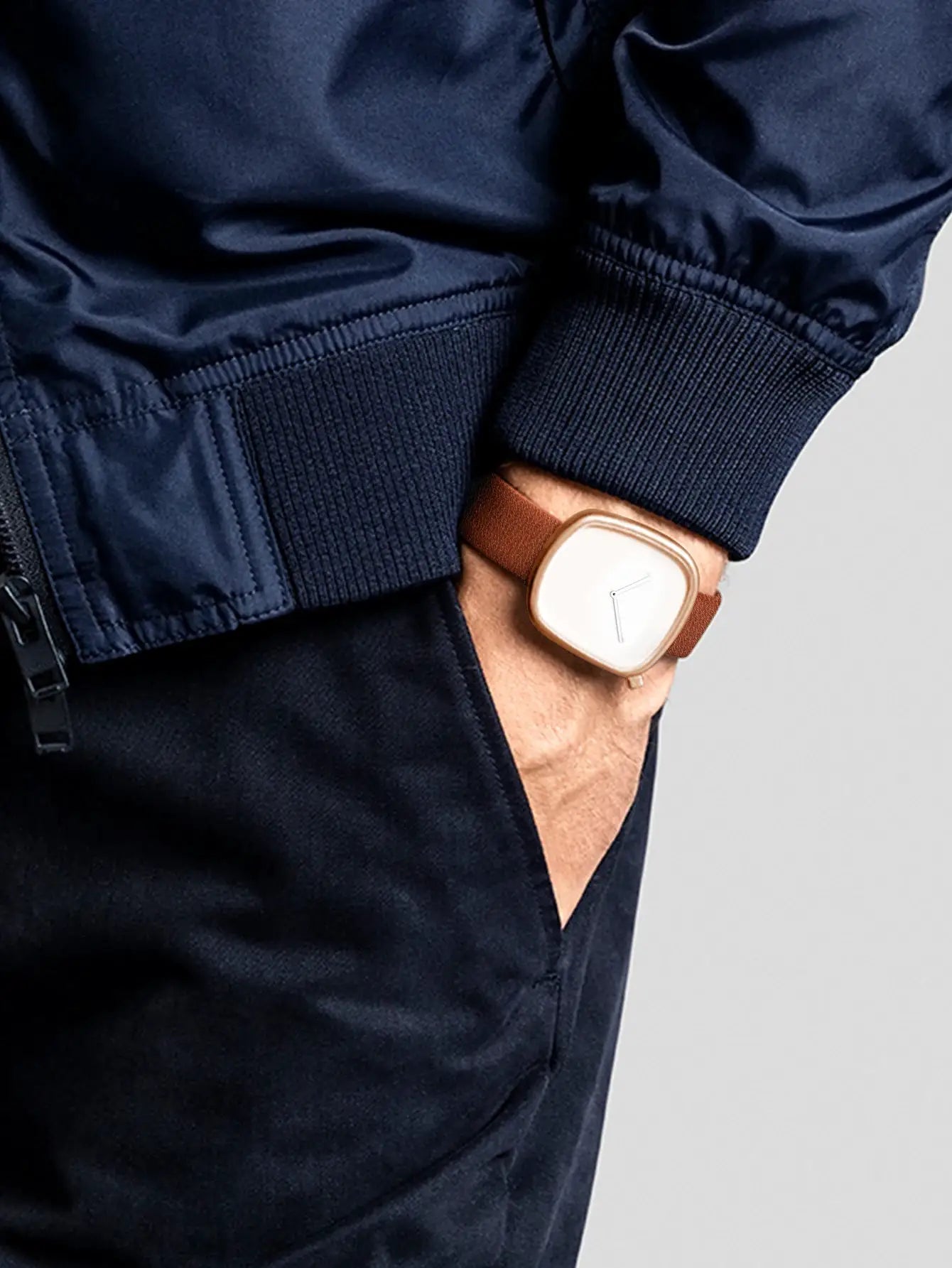 TOMI minimalist square watch with a rose-gold case and brown leather strap.