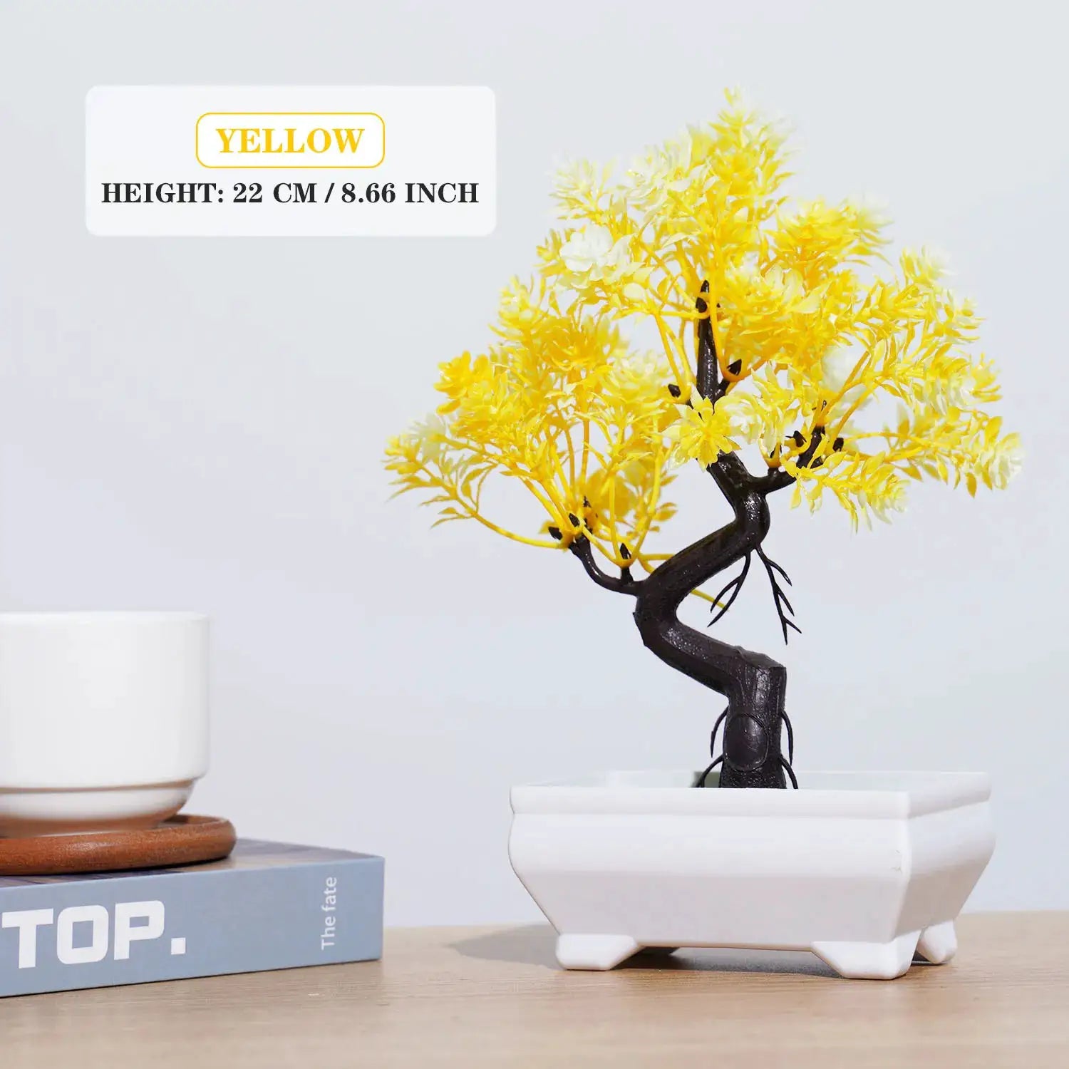 Artificial bonsai tree with yellow blossoms in a white pot for tabletop decor