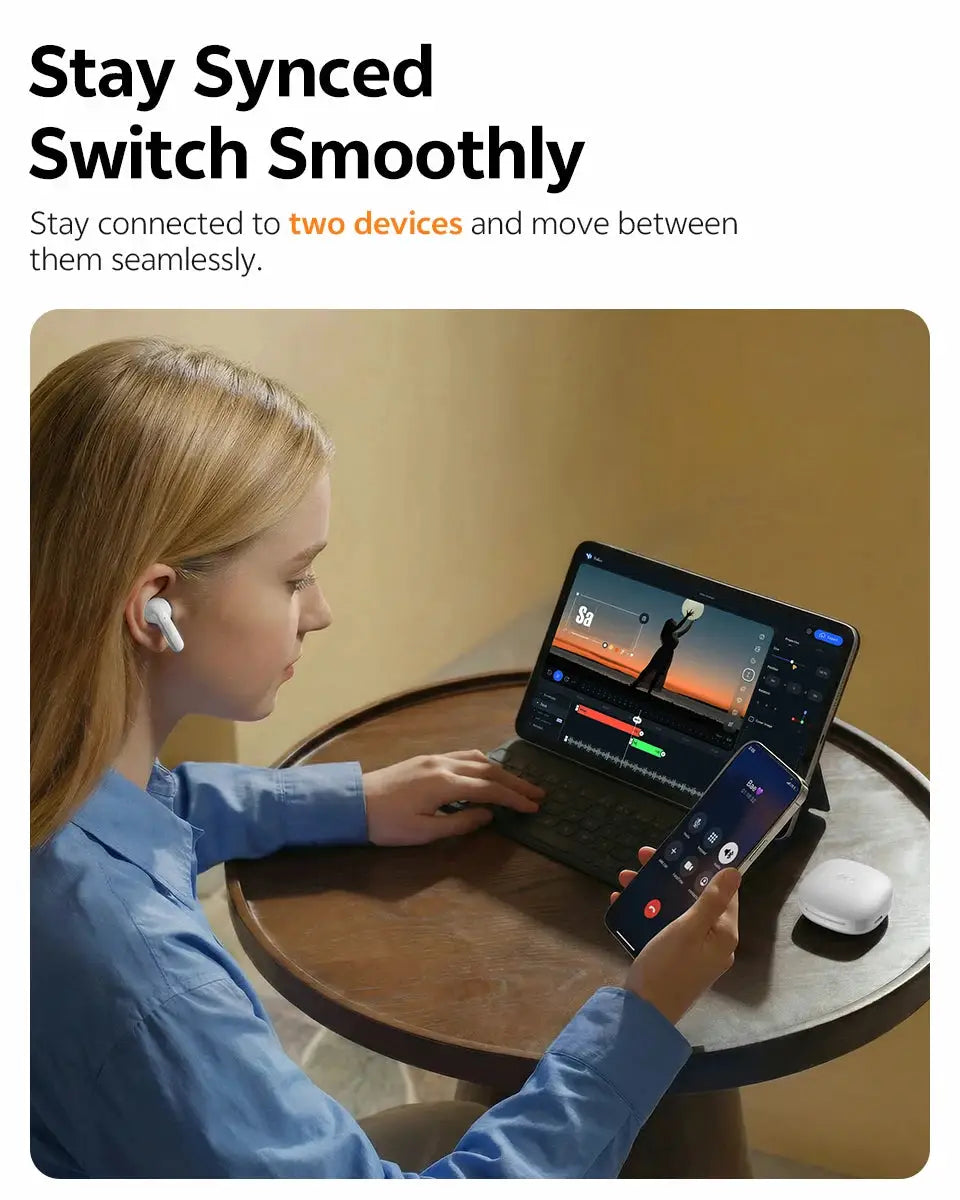 QCY T13 Pro HT23 adaptive ANC wireless earbuds with white charging case, worn at a table with laptop and phone